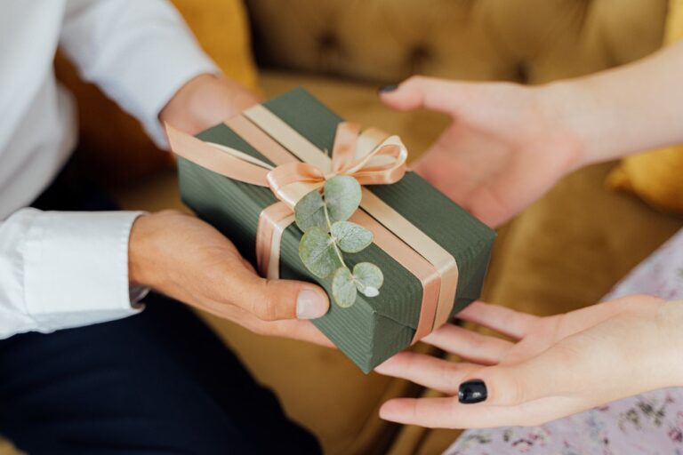 Groen cadeaupakketje wordt aan een collega gegeven